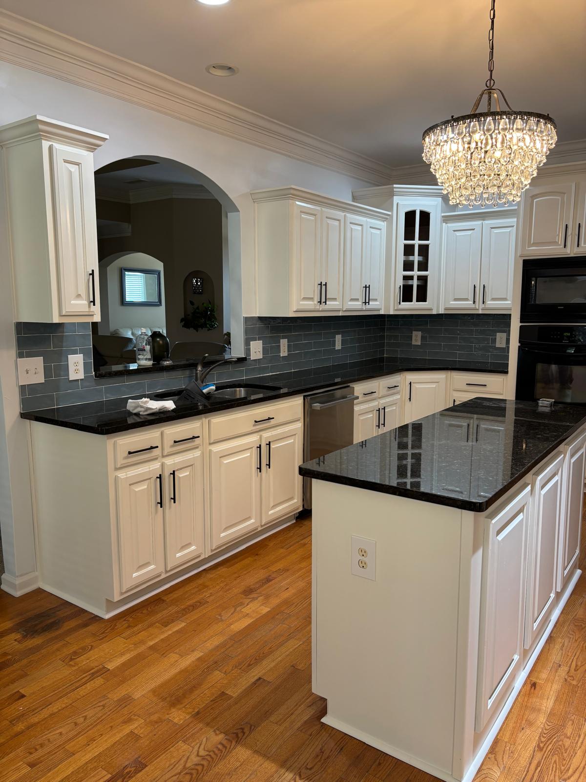 Kitchen island and dark tile backsplash after an interior remodel in Metro Atlanta, GA