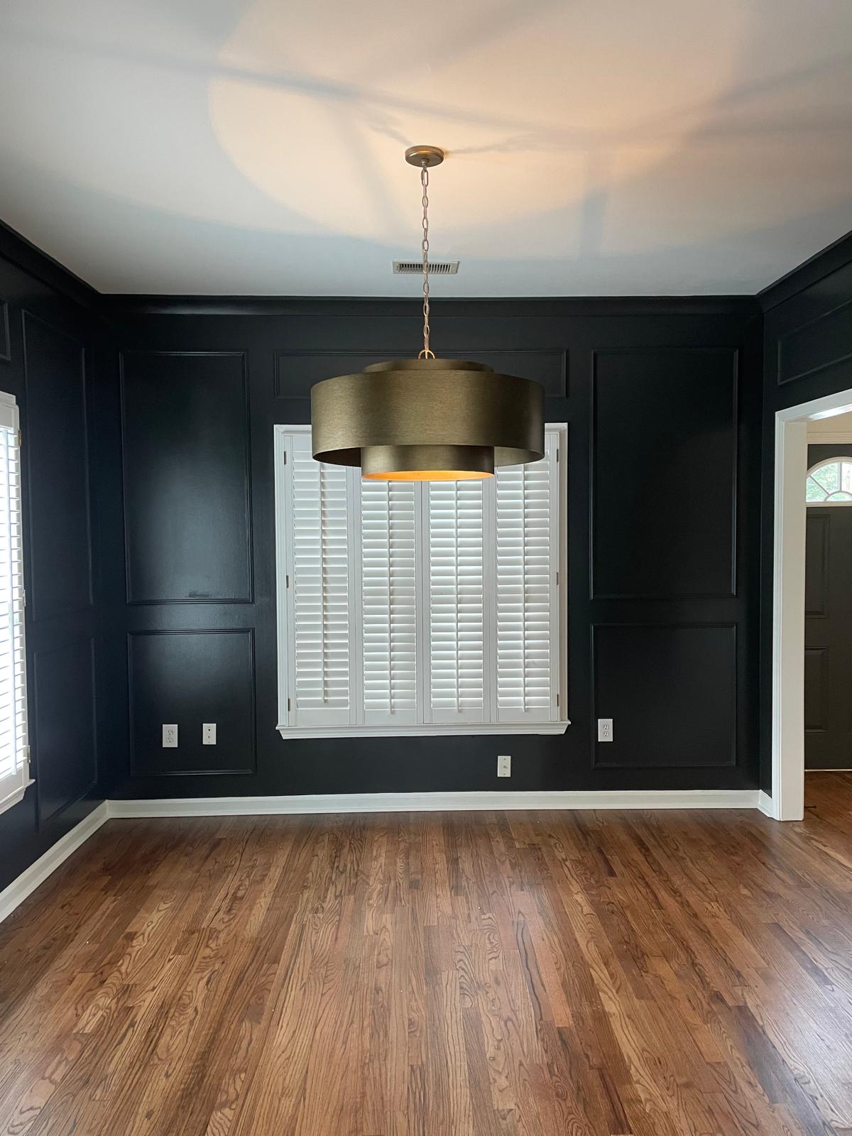 Custom picture-frame wall paneling painted black in a dining room in Metro Atlanta, GA