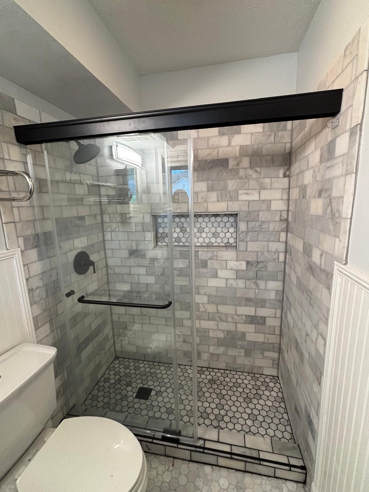 Finished marble subway tile walk-in shower with hexagon mosaic floor in Metro Atlanta, GA